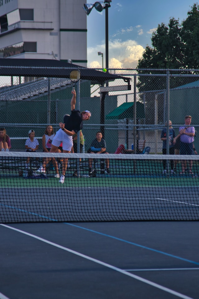 Tennis players engaged in an intense but friendly match, demonstrating the passion and commitment of regular players