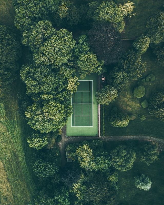 Diverse group of people playing tennis outdoors, showing the sport's accessibility and social appeal