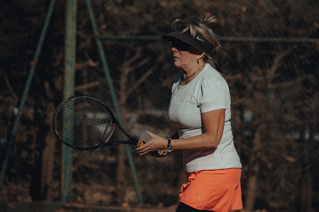 Tennis player in action showing intense focus and athletic movement, demonstrating the mental and physical demands of the sport